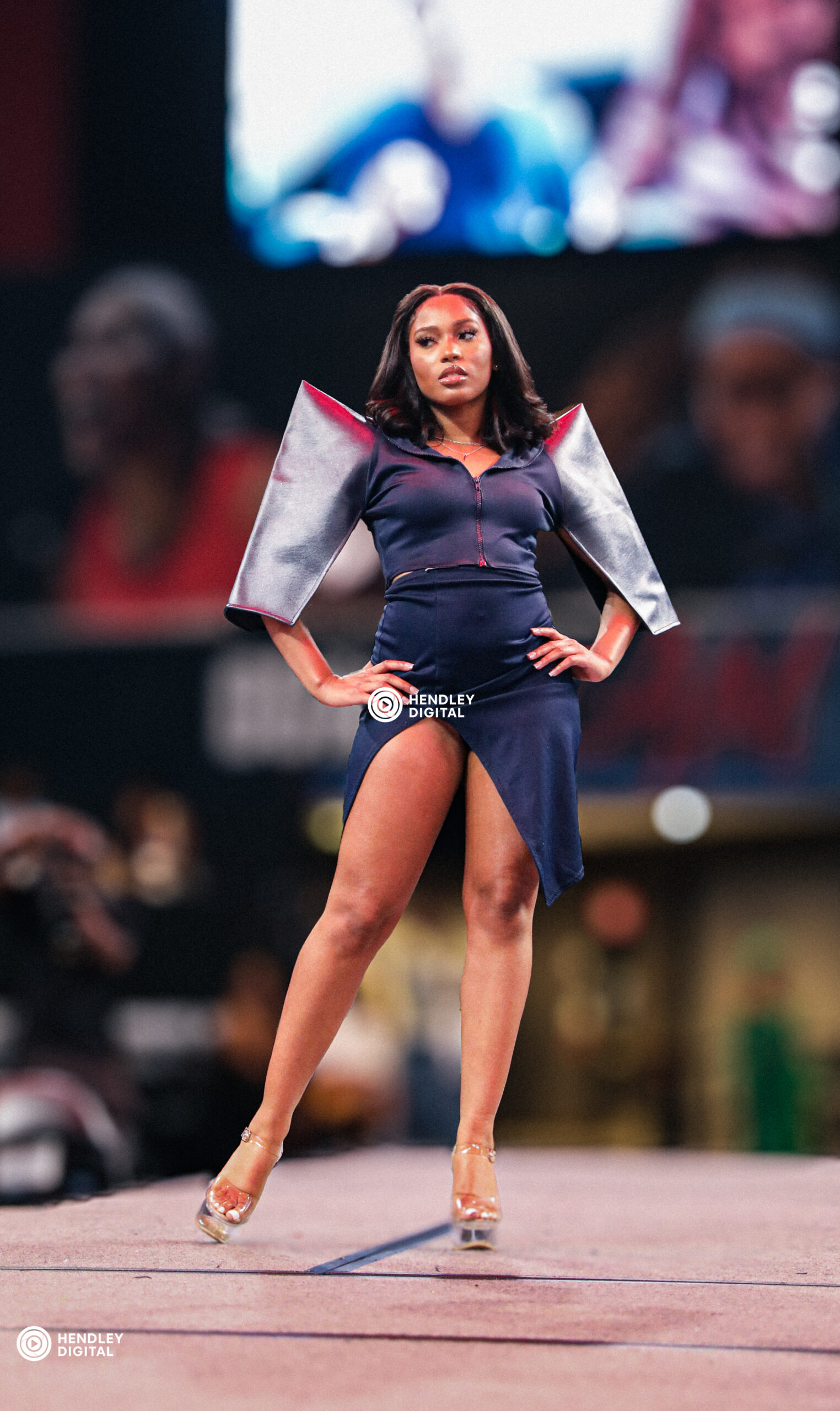 Female model in blue posing under stage lights during an Atlanta runway show part of our photography portfolio.
